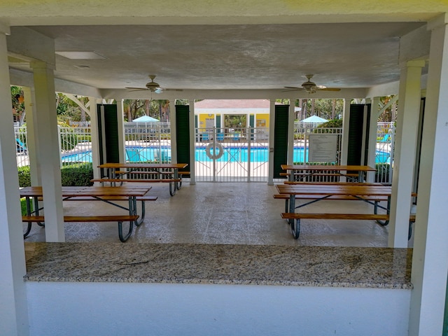 3032 W Community Dr, Jupiter, FL 33458 - view of patio / terrace with a ceiling fan and a community pool