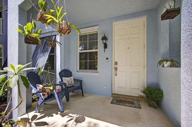 3032 W Community Dr, Jupiter, FL 33458 - property entrance with covered porch and stucco siding