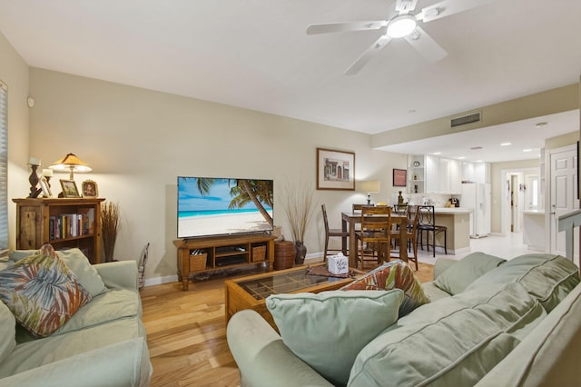 3032 W Community Dr, Jupiter, FL 33458 - living room with light wood-style flooring and a ceiling fan