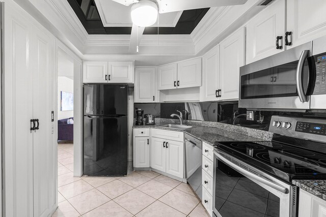 2400 Presidential Way Unit 903, West Palm Beach, FL 33401 - kitchen featuring stainless steel appliances, white cabinetry, crown molding, light tile patterned flooring, and dark stone countertops