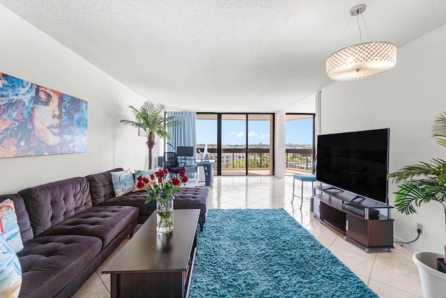 2400 Presidential Way Unit 903, West Palm Beach, FL 33401 - living area featuring floor to ceiling windows, light tile patterned floors, and a textured ceiling
