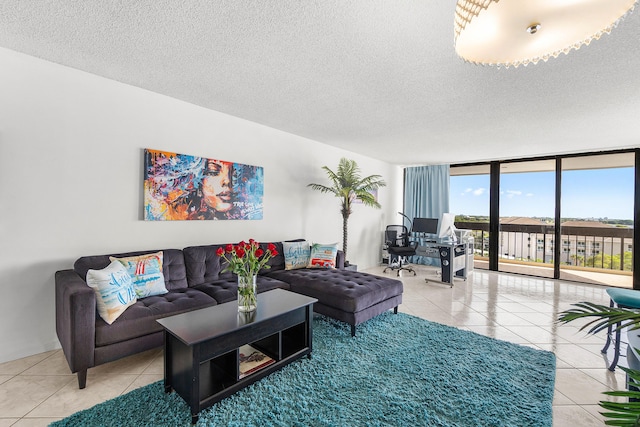 2400 Presidential Way Unit 903, West Palm Beach, FL 33401 - living area with tile patterned floors, expansive windows, a textured ceiling, and a desk