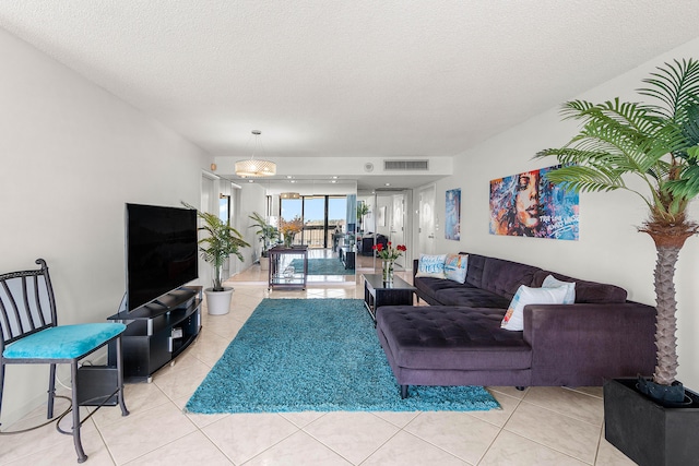 2400 Presidential Way Unit 903, West Palm Beach, FL 33401 - living area featuring light tile patterned floors and a textured ceiling
