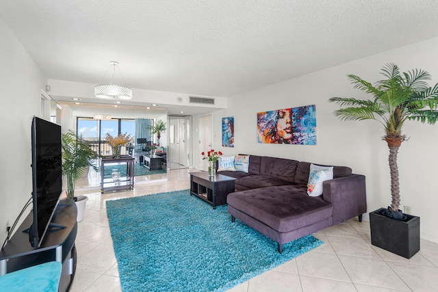 2400 Presidential Way Unit 903, West Palm Beach, FL 33401 - living room featuring light tile patterned flooring and a textured ceiling