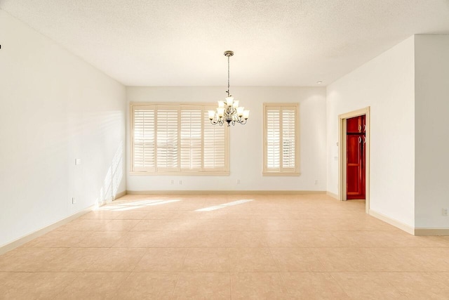 2619 SW Greenwich Way, Palm City, FL 34990 - empty room with a chandelier, light tile patterned floors, and a textured ceiling