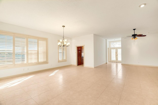 2619 SW Greenwich Way, Palm City, FL 34990 - spare room featuring a chandelier, ceiling fan, and light tile patterned flooring
