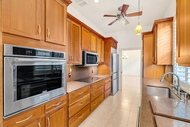 2619 SW Greenwich Way, Palm City, FL 34990 - kitchen with appliances with stainless steel finishes, backsplash, a ceiling fan, brown cabinetry, and light tile patterned floors