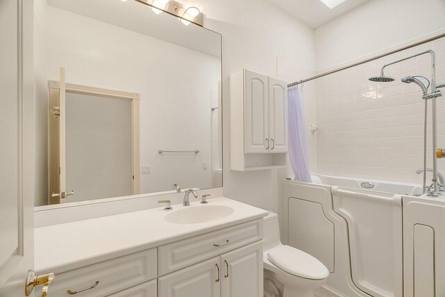 2619 SW Greenwich Way, Palm City, FL 34990 - full bathroom featuring vanity and shower / bath combination with curtain