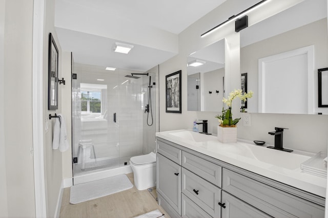 930 Dogwood Dr Unit 358, Delray Beach, FL 33483 - full bathroom featuring double vanity, a stall shower, and wood finished floors