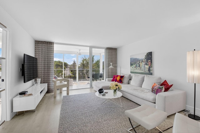 930 Dogwood Dr Unit 358, Delray Beach, FL 33483 - living room with expansive windows and light wood-style flooring
