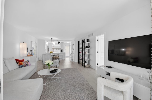 930 Dogwood Dr Unit 358, Delray Beach, FL 33483 - living area featuring light wood-style floors and a chandelier