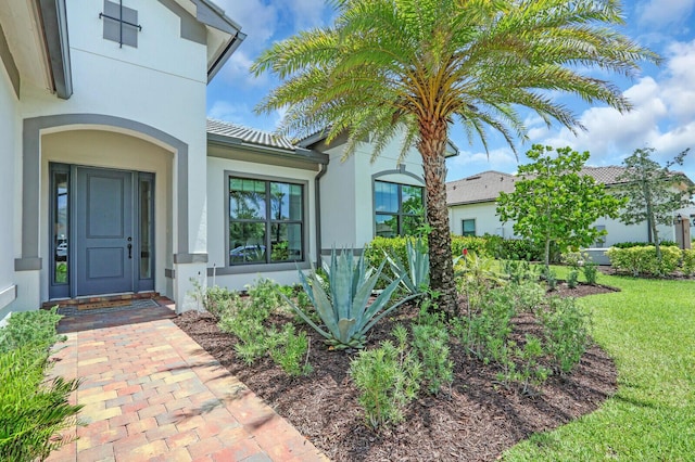 9109 Balsamo Dr, Palm Beach Gardens, FL 33412 - doorway to property featuring stucco siding