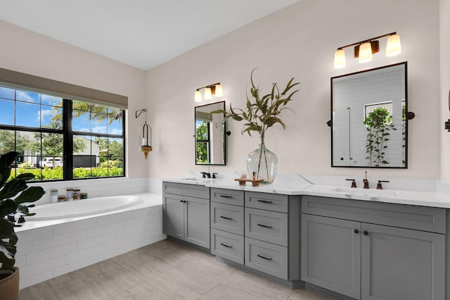9109 Balsamo Dr, Palm Beach Gardens, FL 33412 - full bathroom with double vanity, a garden tub, healthy amount of natural light, and tile patterned flooring