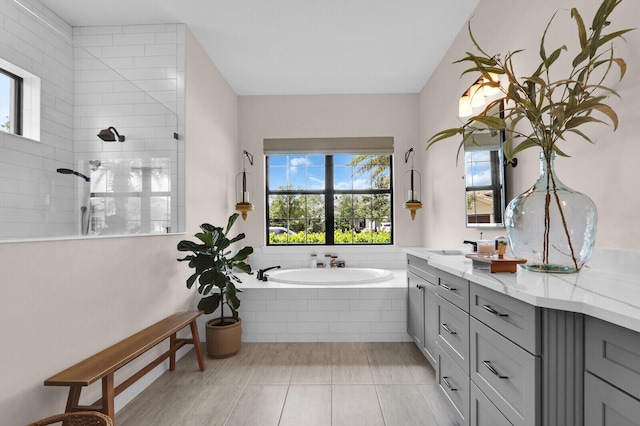 9109 Balsamo Dr, Palm Beach Gardens, FL 33412 - bathroom with healthy amount of natural light, a garden tub, double vanity, and a walk in shower