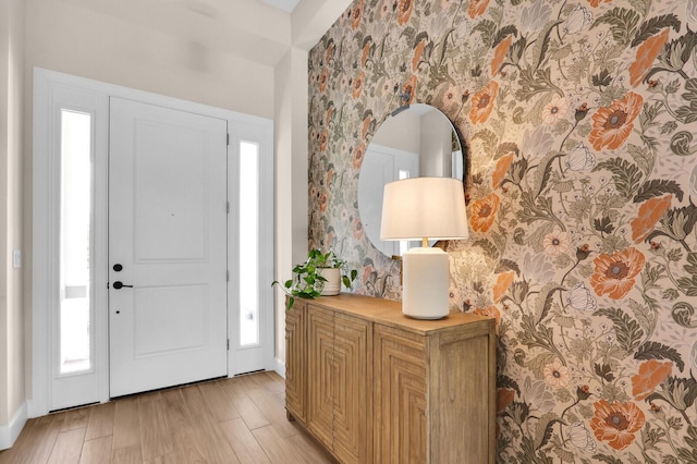 9109 Balsamo Dr, Palm Beach Gardens, FL 33412 - foyer entrance featuring light wood-style floors, wallpapered walls, and healthy amount of natural light