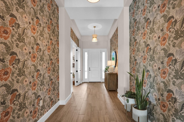 9109 Balsamo Dr, Palm Beach Gardens, FL 33412 - entryway featuring wood finished floors and wallpapered walls