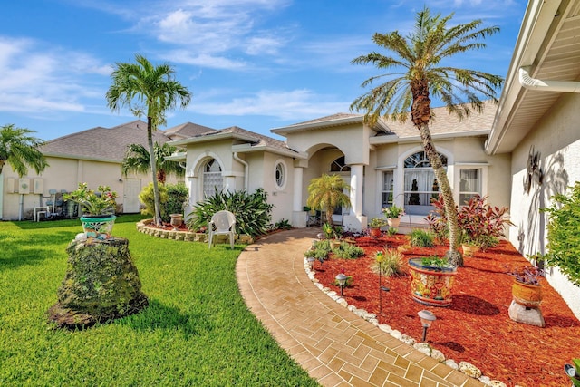 1380 SW Sultan Dr, Port Saint Lucie, FL 34953 - mediterranean / spanish-style home featuring stucco siding and a front lawn