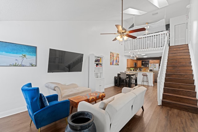 1864 Adventure Pl Unit 1864, North Lauderdale, FL 33068 - living room featuring stairway, ceiling fan, wood finished floors, high vaulted ceiling, and a skylight