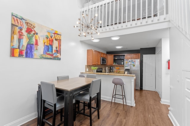 1864 Adventure Pl Unit 1864, North Lauderdale, FL 33068 - dining space featuring wood finished floors, a chandelier, and a towering ceiling
