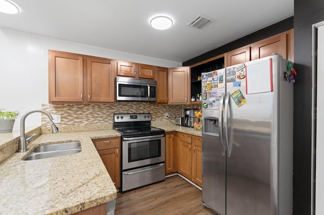 1864 Adventure Pl Unit 1864, North Lauderdale, FL 33068 - kitchen featuring appliances with stainless steel finishes, backsplash, wood finished floors, open shelves, and brown cabinets