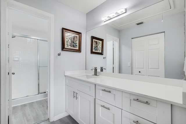 1102 Republic Ct, Deerfield Beach, FL 33442 - bathroom featuring a shower stall, vanity, and wood finished floors