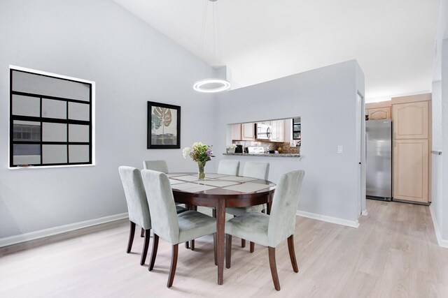 1102 Republic Ct, Deerfield Beach, FL 33442 - dining space featuring light wood finished floors and high vaulted ceiling