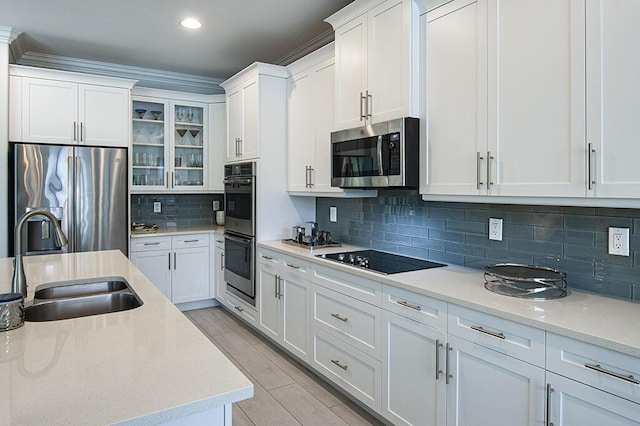 3165 Berkley Square Way, Vero Beach, FL 32966 - kitchen with appliances with stainless steel finishes, white cabinets, glass insert cabinets, decorative backsplash, and recessed lighting