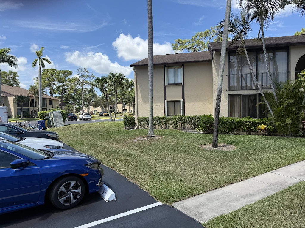 414 Pine Glen Ln Unit B-1, Greenacres, FL 33463 - view of building exterior featuring uncovered parking