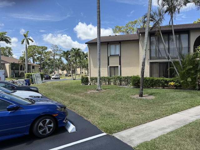 414 Pine Glen Ln Unit B-1, Greenacres, FL 33463 - view of building exterior featuring uncovered parking