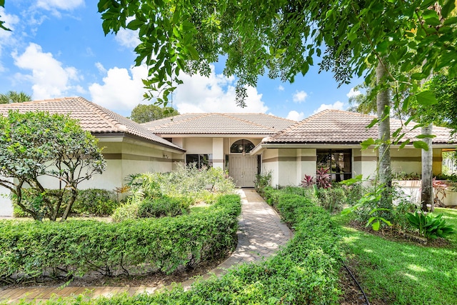 2029 Greenview Cove Dr, Wellington, FL 33414 - view of front facade with stucco siding and a tile roof