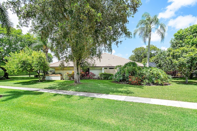 2029 Greenview Cove Dr, Wellington, FL 33414 - view of front of home featuring a tile roof, a front yard, and stucco siding
