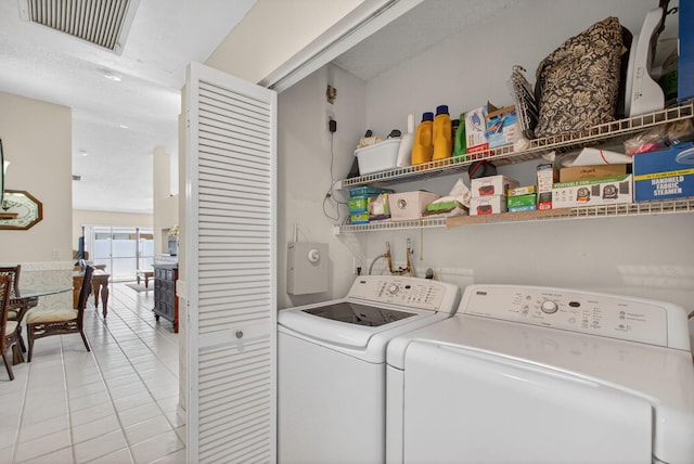 4640 Homestead Way Unit 39, West Palm Beach, FL 33417 - laundry area featuring washing machine and dryer and light tile patterned floors