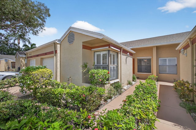 4640 Homestead Way Unit 39, West Palm Beach, FL 33417 - view of front of house with stucco siding and a garage