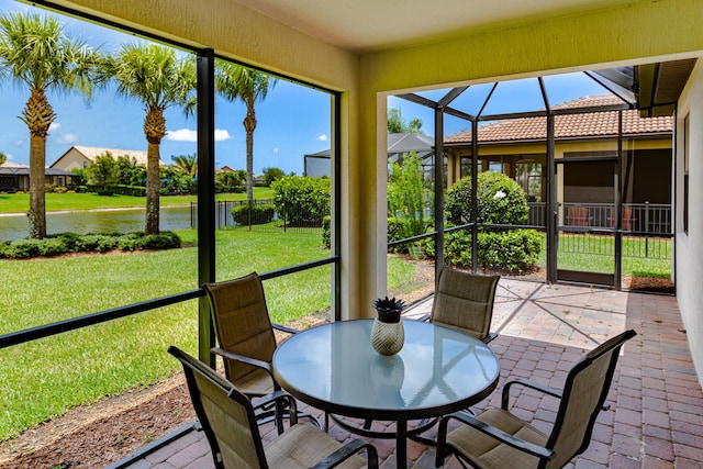 649 SE Monteiro Dr, Port Saint Lucie, FL 34984 - sunroom featuring a water view, outdoor dining area, and plenty of natural light