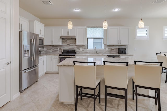 649 SE Monteiro Dr, Port Saint Lucie, FL 34984 - kitchen with appliances with stainless steel finishes, decorative backsplash, white cabinets, and recessed lighting