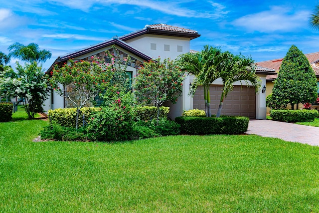 649 SE Monteiro Dr, Port Saint Lucie, FL 34984 - mediterranean / spanish house featuring a garage, a front yard, stucco siding, and driveway