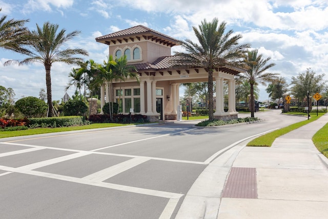 649 SE Monteiro Dr, Port Saint Lucie, FL 34984 - view of asphalt street featuring traffic signs, sidewalks, and curbs