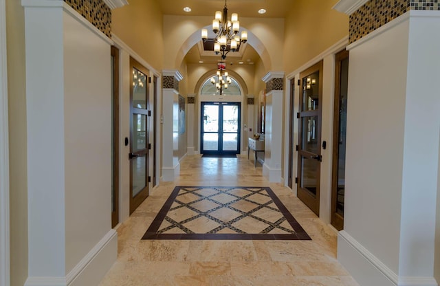 649 SE Monteiro Dr, Port Saint Lucie, FL 34984 - entrance foyer featuring a chandelier, a towering ceiling, french doors, arched walkways, and recessed lighting