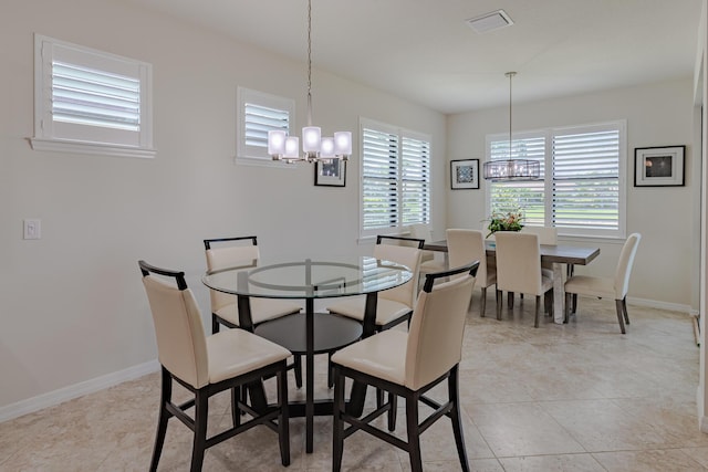 649 SE Monteiro Dr, Port Saint Lucie, FL 34984 - dining space featuring a chandelier, plenty of natural light, and light tile patterned floors