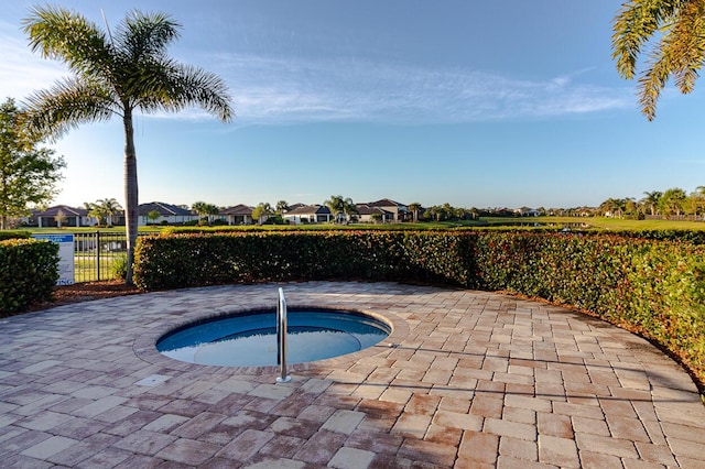 649 SE Monteiro Dr, Port Saint Lucie, FL 34984 - view of swimming pool featuring a residential view, a community hot tub, and a patio area