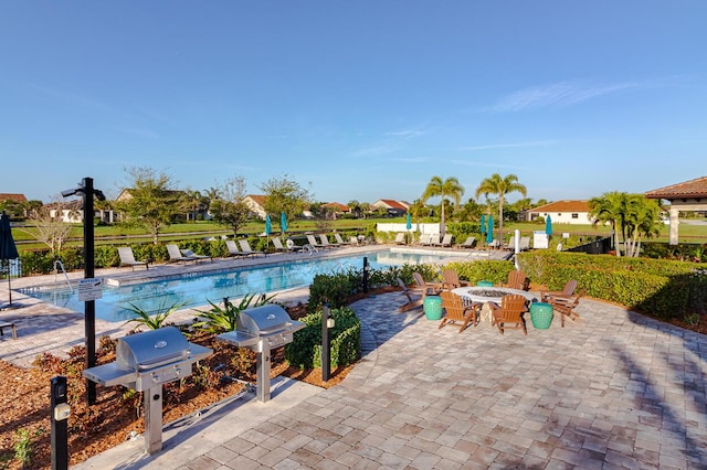 649 SE Monteiro Dr, Port Saint Lucie, FL 34984 - community pool featuring a patio area and a grill