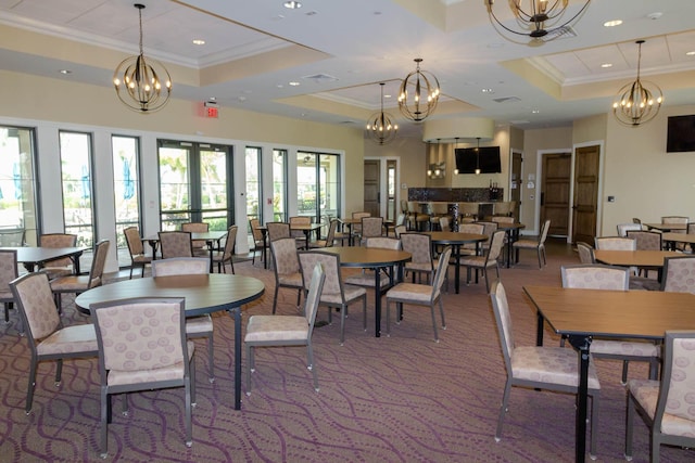 649 SE Monteiro Dr, Port Saint Lucie, FL 34984 - dining area featuring crown molding, a tray ceiling, a chandelier, recessed lighting, and carpet flooring
