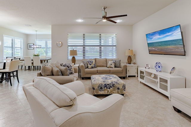 649 SE Monteiro Dr, Port Saint Lucie, FL 34984 - living room with ceiling fan, light tile patterned floors, a chandelier, and recessed lighting