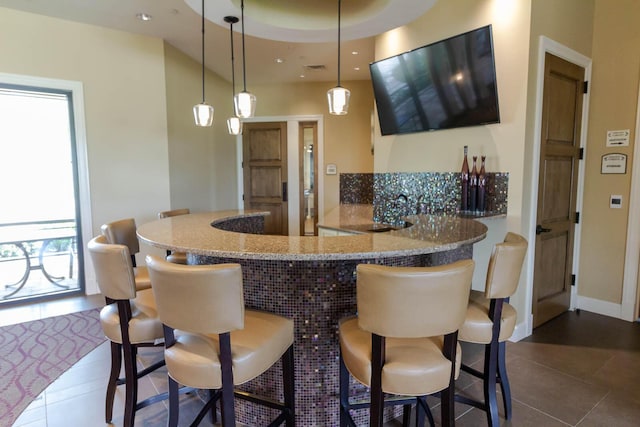 649 SE Monteiro Dr, Port Saint Lucie, FL 34984 - bar area with dark tile patterned floors and hanging light fixtures