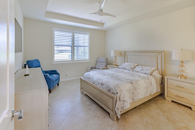 649 SE Monteiro Dr, Port Saint Lucie, FL 34984 - bedroom with light tile patterned flooring, a tray ceiling, and a ceiling fan