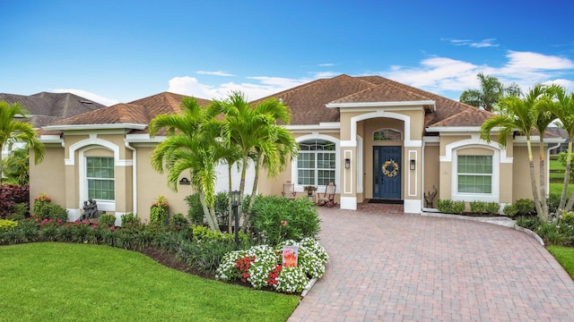 780 SW Fortunella Cir SW, Vero Beach, FL 32968 - mediterranean / spanish-style house featuring stucco siding and a front lawn