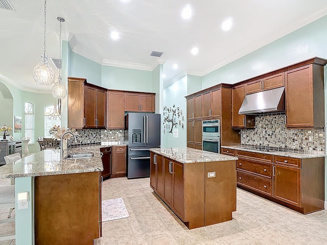780 SW Fortunella Cir SW, Vero Beach, FL 32968 - kitchen featuring appliances with stainless steel finishes, under cabinet range hood, arched walkways, light stone countertops, and ornamental molding