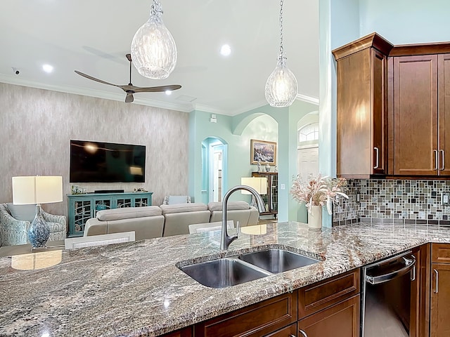 780 SW Fortunella Cir SW, Vero Beach, FL 32968 - kitchen with stainless steel dishwasher, arched walkways, stone countertops, ceiling fan, and crown molding