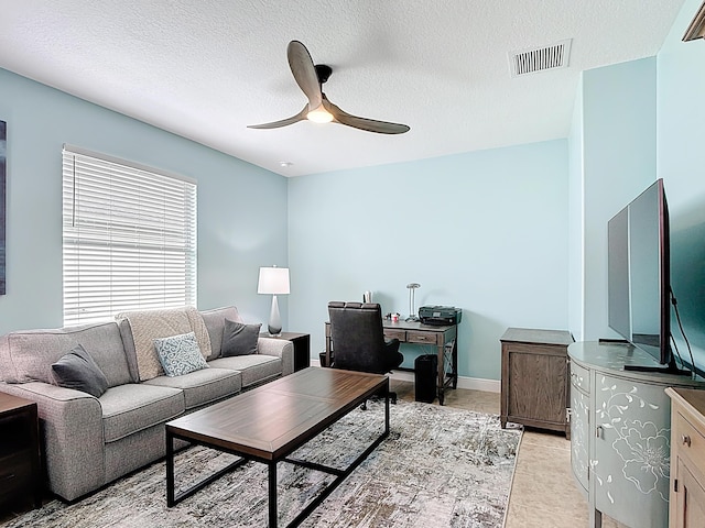 780 SW Fortunella Cir SW, Vero Beach, FL 32968 - living room featuring a ceiling fan, a desk, and a textured ceiling