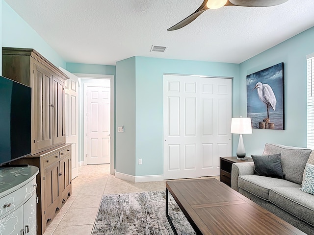 780 SW Fortunella Cir SW, Vero Beach, FL 32968 - living area featuring ceiling fan, light tile patterned floors, and a textured ceiling